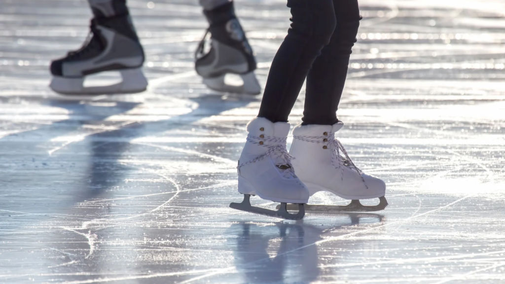 Frau auf Eislaufbahn die Schlittschuh fährt